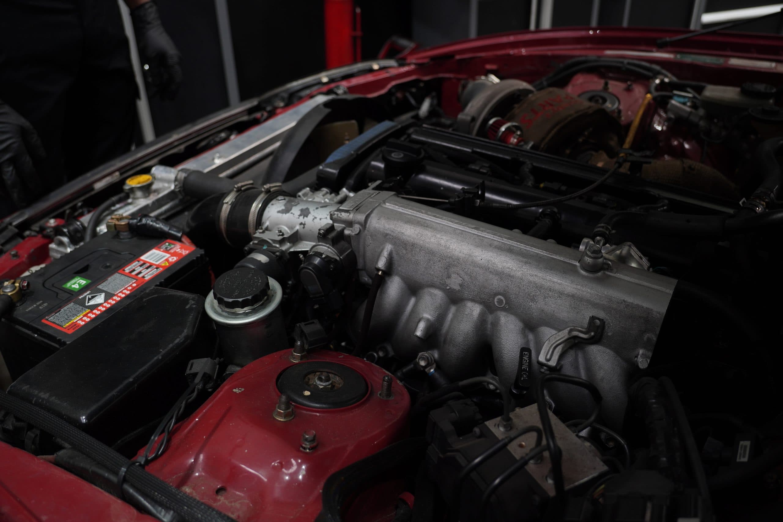 Engine bay of a turbocharged car in the ASR workshop
