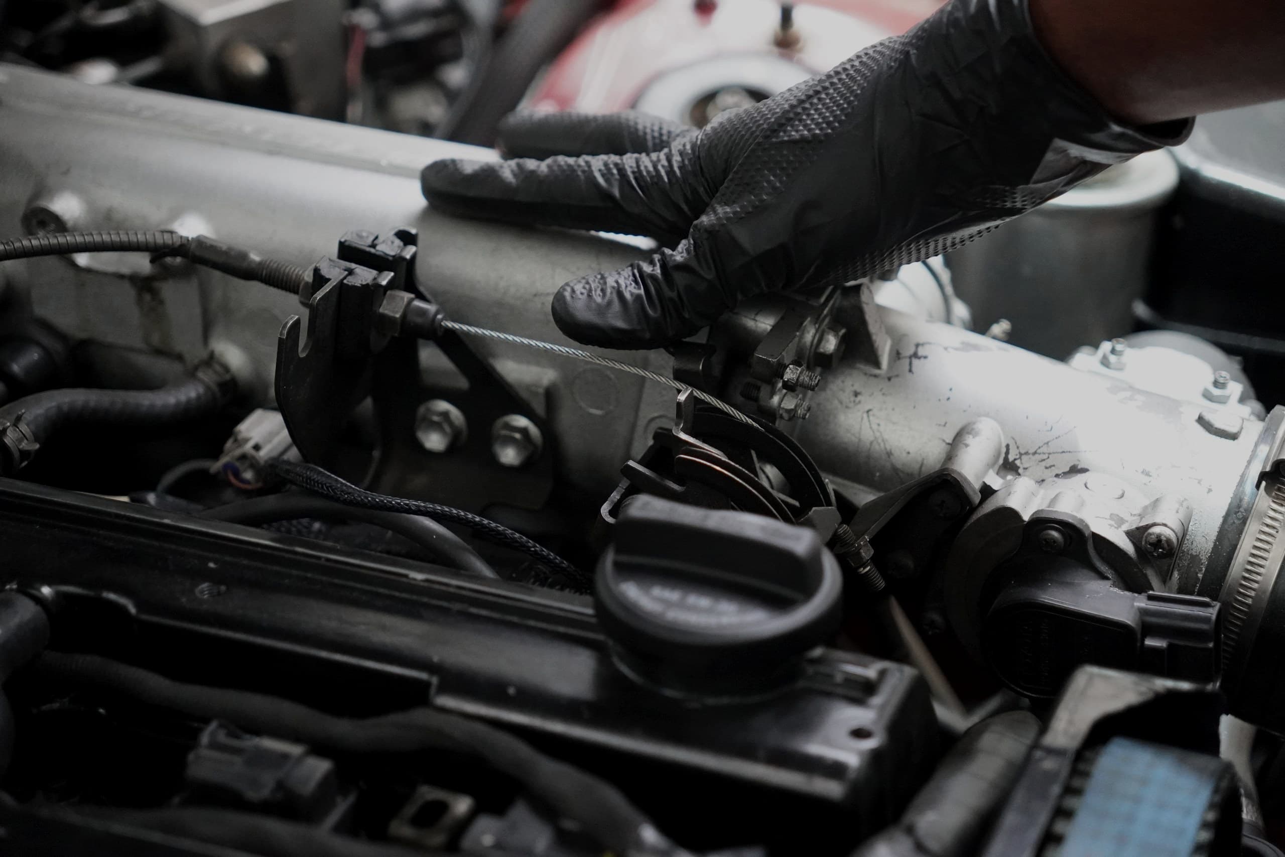 ASR technician's hands working on an engine