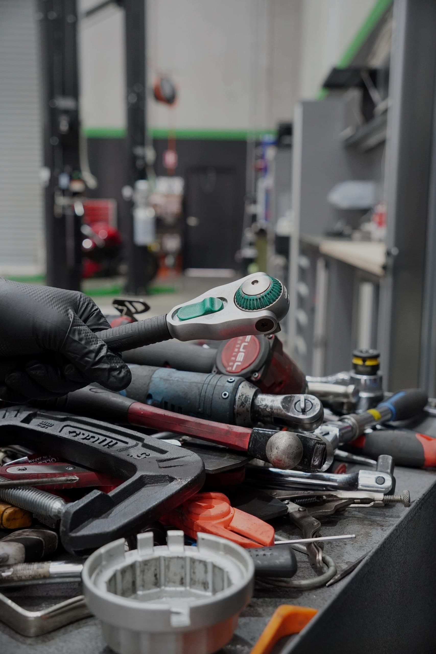 Technician picking a ratchet from the tool bench in the ASR workshop